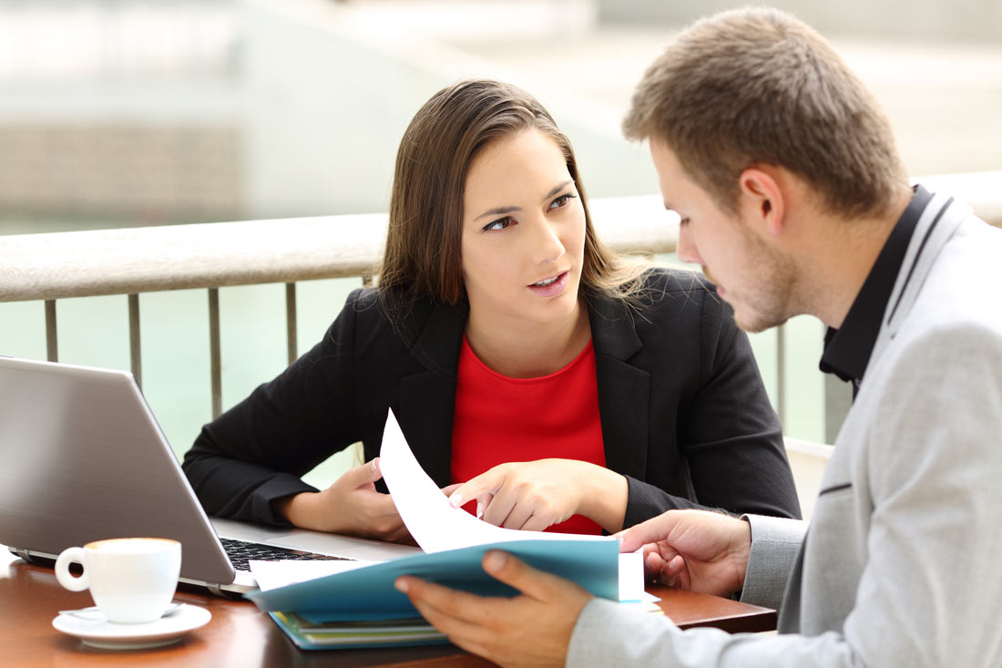 Intensive English one-to.one course. The teacher and the participant are sitting at a table outside.