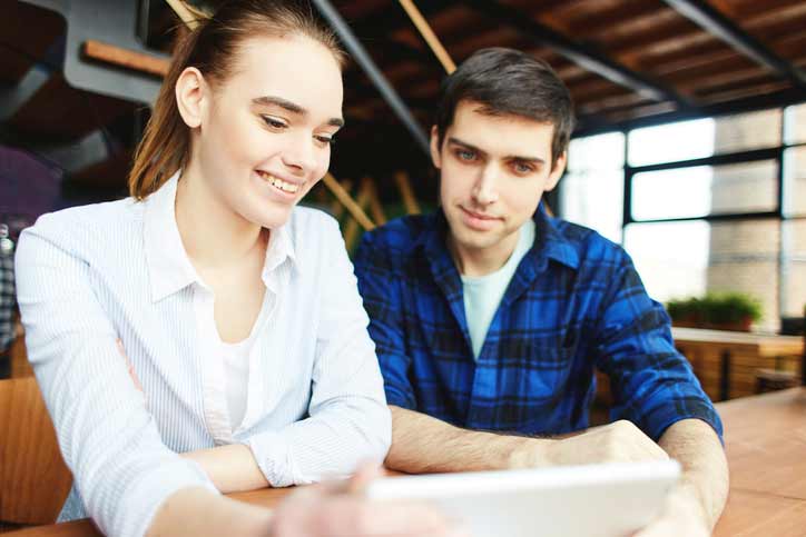 An intensive immersion one-to-one French course . The teacher and the participant are sitting at a table.