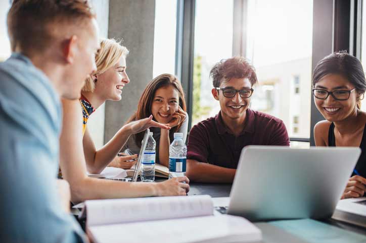 German course in a small group. The teacher and the participants are laughing.