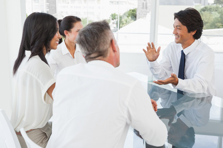 Learning Japanese in a company. Did Japanese teacher is sitting at The table opposite the students.